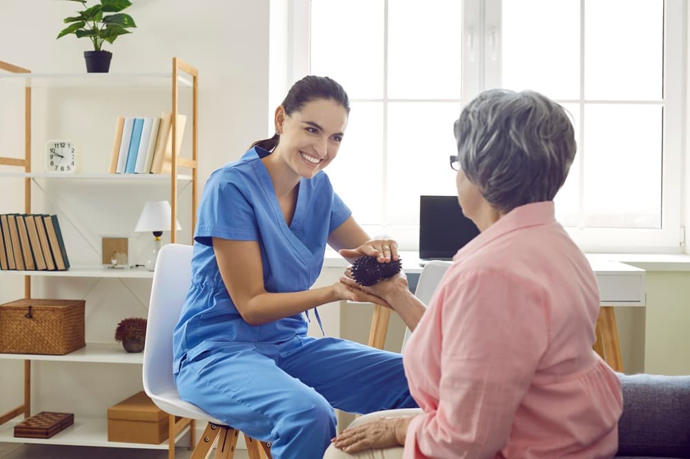 A compassionate carer gently assisting an elderly person with grooming.